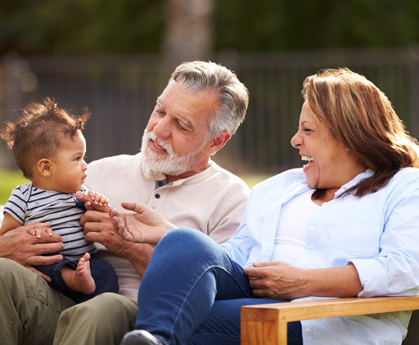 grandparents with a baby happy after qualifying  for a reverse mortgage