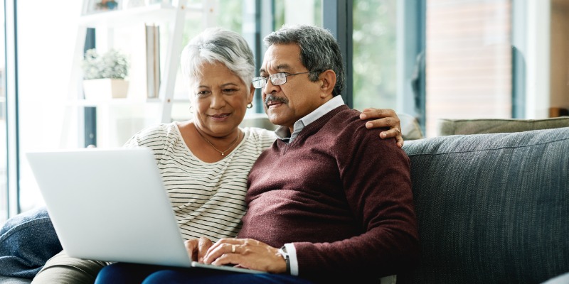 Older couple reviwing information on laptop